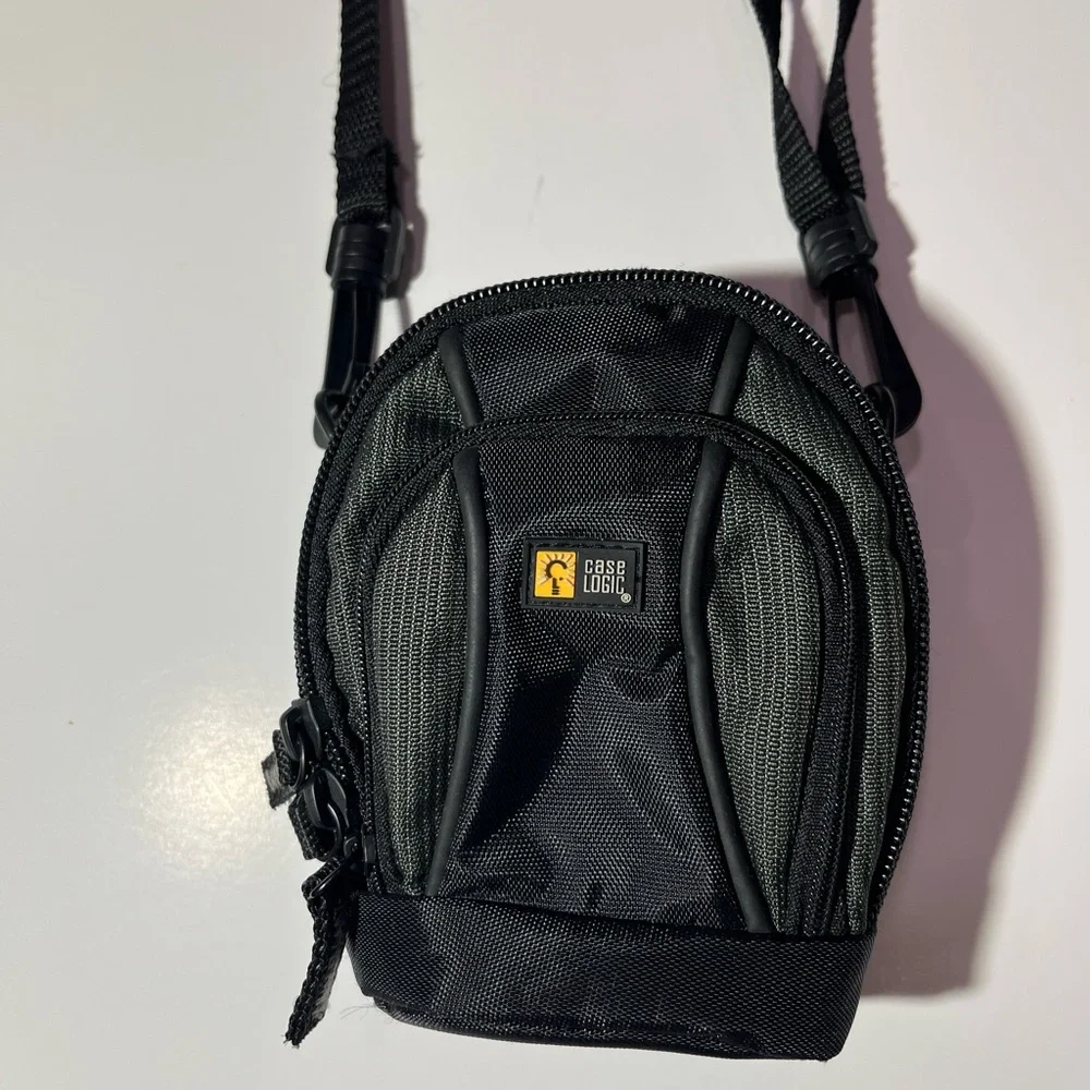 Case Logic Small black/dark green camera case with shoulder strap.